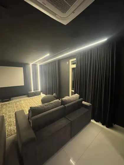 Cortina de tecido escura em home theater com iluminação de LED